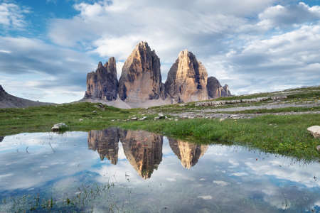 Mountains reflection on the water surface. Natural landscape in the Dolomites Alps in the Italy. Tre Cime di Lavaredo mountainsの写真素材