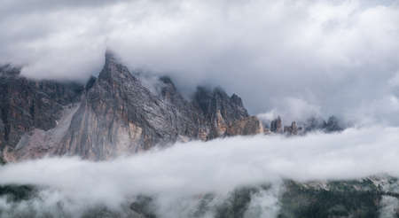 Mountain panorama in the Dolomite Alps, Italy. Mountain ridge in the clouds. Beautiful landscape at the summer timeの写真素材