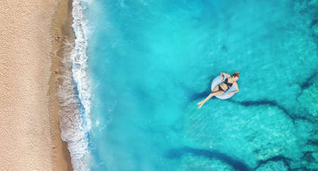 Aerial view at the girl on sea. Turquoise water from air as a background from air. Natural seascape at the summer time. Seascape from droneの写真素材