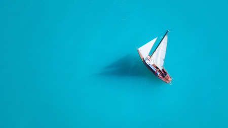 Yacht on the water surface from top view. Turquoise water background from top view. Summer seascape from air. Travel concept and ideaの写真素材