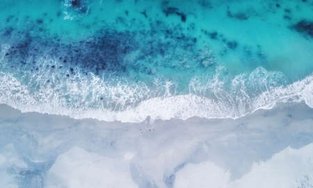 Beach and waves from top view. Turquoise water background from top view. Summer seascape from air....