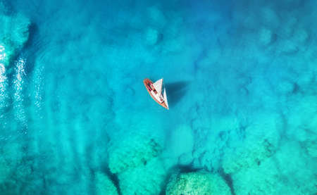 Yacht on the sea from top view. Turquoise water background from top view. Summer seascape from air. Travel concept and ideaの写真素材