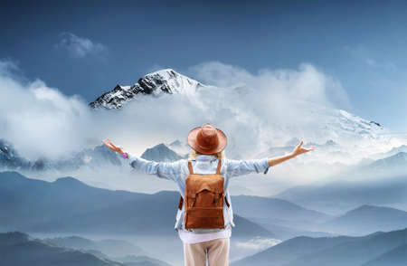 Traveler at the mountains landscape Travel and active life concept. Adventure and travel in the mountains region. People with backpack as a travelerの写真素材