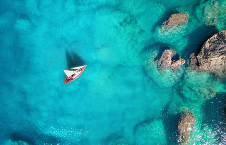Yacht on the sea from top view. Turquoise water background from top view. Summer seascape from air. Travel concept and ideaの写真素材