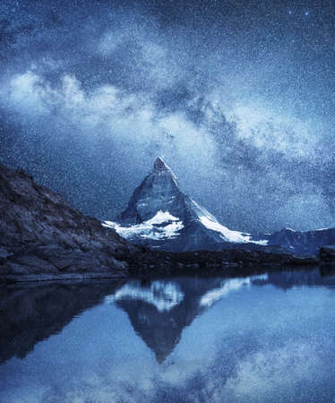 Matterhorn and reflection on the water surface at the night time. Milky way above Matterhorn, Switzerland. Beautiful natural landscape in the Switzerlandの写真素材