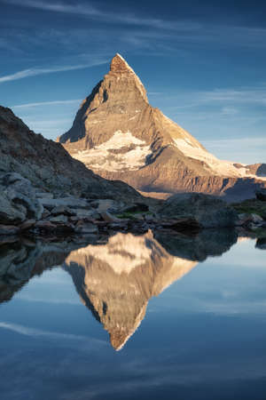 Matterhorn and reflection on the water surface during sunrise. Beautiful natural landscape in the Switzerland. Matterhorn, Zermatt, Switzerland-Imageの写真素材