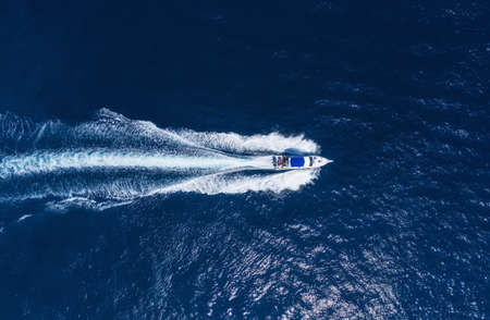 Yachts at the sea in Bali, Indonesia. Aerial view of luxury floating boat on transparent turquoise water at sunny day. Summer seascape from air. Top view from drone. Seascape with motorboat in bay. Travel - imageの写真素材