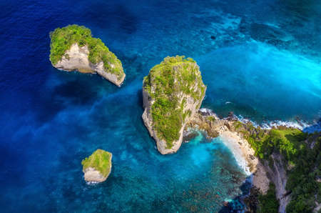 Aerial view at sea and rocks. Turquoise water background from top view. Summer seascape from air....