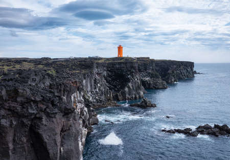 Lighthouse on the rocks in the Iceland. High rocks and lighthouse at the day time. Natural landscape at the summer. Iceland - imageの写真素材