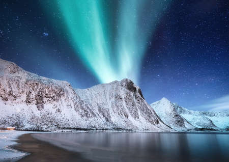 Aurora Borealis, Senja islands, Norway. Northen lights, mountains and reflection on the water. Winter landscape during polar lights. Norway travel - imageの写真素材
