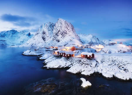 View on the house in the Hamnoy village, Lofoten Islands, Norway. Landscape in winter time during blue hour. Mountains and water. Travel - imageの写真素材