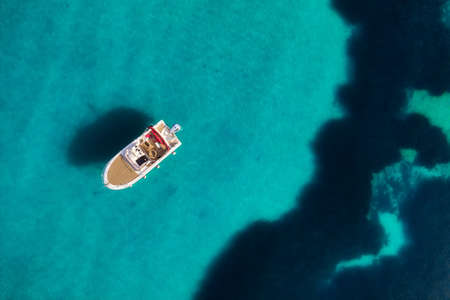 Croatia. Boat and sea as a background from top view. Turquoise water background from top view. Beach and waves. Travel - imageの写真素材