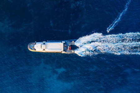 Aerial view of floating ship on blue Adriatic sea at sunny day. Fast ship on the sea surface....