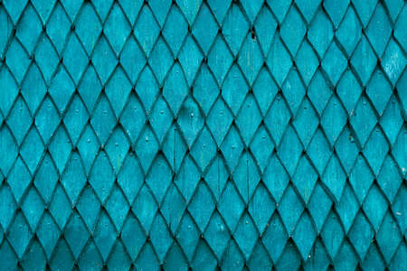 The wall of the house is made of old wood. Wooden details in the form of a rhombus. Background and...