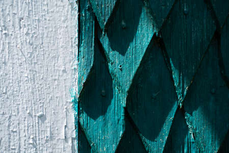 The wall of the house is made of old wood. Wooden details in the form of a rhombus. Background and texture of old painted wood.の写真素材