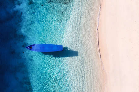 Boat on the beach. Seascape from drone. Blue water background from top view. Summer seascape from air. Gili Meno island, Indonesia. Travel - imageの写真素材