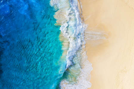 Beach and large ocean waves. Coast as a background from top view. Blue water background from drone. Summer seascape from air. Travel imageの写真素材