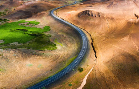 Aerial view on road in Iceland. Aerial landscape above highway in the geysers valley. Icelandic landscape from air. Famous place. Travel and vacation imageの写真素材