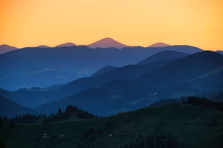 View of a mountains range. Landscape during sunset at the summer time. Foggy hills in the mountains ragion. Travel image. Spring landscape.の写真素材