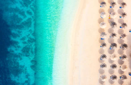 Aerial view on beach and umbrellas. Vacation and adventure. Top view from drone at beach and blue sea. Croatia. Travel and vacation imageの写真素材