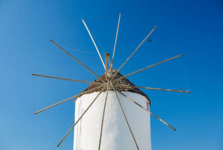 Mykonos, Greece. Traditional windmills. The symbol of Mykonos at the day time. Landscape with traditional windmils. Photo for travel and vacation.の写真素材