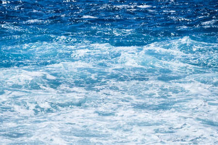 Waves and blue water as a background. View at the ocean surface. Natural summer seascape. Water background. Abstract blue ocean background.の写真素材