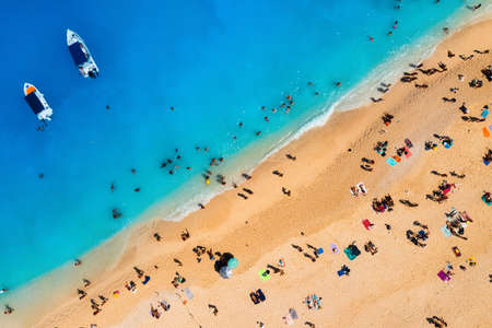 Aerial view of Navagio beach, Zakynthos Island, Greece. People relaxing on the beach during their...