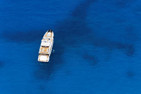 Aerial view at the yacht at the day time. Adventure and travel.  Landscape with yacht in Greece. Luxury cruise. Travel and vacation image. Aerial seascape.の写真素材