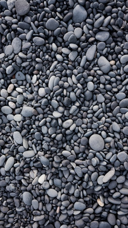 Gray pebbles as a background in the Iceland sea shore. Abstract composition. Image for design and wallpaper on phone.の写真素材