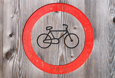 A forbidding sign for bicycles. Wood as a background. Texture of natural wood. Large resolution photo for the design.の写真素材