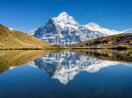 High mountains and reflection on the surface of the lake. Mountain valley with lake. Landscape in the highlands in the summertime. Photo in high resolution.の写真素材