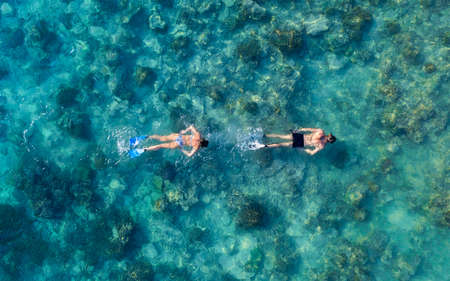 The people are snorkeling near the famous place on Gili Meno Island, Indonesia. Aerial view. Underwater tourism in the ocean. Gili Meno Island, Indonesia. Travel - imageの写真素材