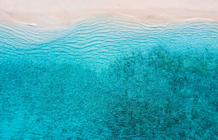Beach and ocean as a background from top view. Azure water background from top view. Summer seascape from air. Travel and vacation imageの写真素材