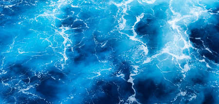 Waves and blue water as a background. View at the ocean surface. Natural summer seascape. Water background. Abstract blue ocean background.の写真素材