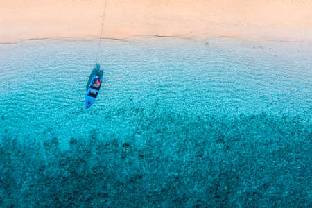 Boats on the water surface from top view. Turquoise water background from top view. Summer seascape from air. Gili Meno island, Indonesia. Travel and vacation imageの写真素材