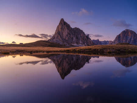 High mountains and reflection on the surface of the lake. Giau Pass, Dolomite Alps, Italy. Landscape in the highlands during sunset. Photo in high resolution.の写真素材