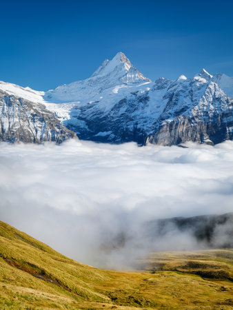 Mountains and clouds in the valley. Natural landscape high in the mountains. Mountain range through the clouds. Landscape in the summertime. Large resolution photo for design.の写真素材