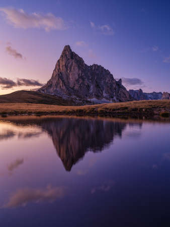 High mountains and reflection on the surface of the lake. Giau Pass, Dolomite Alps, Italy. Landscape in the highlands during sunset. Photo in high resolution.の写真素材
