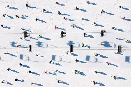 Ski resort. Aerial view of skiers and snowboarders. Winter sports. Snow slope in the mountains for sports. Photo in high resolution for the background.の写真素材