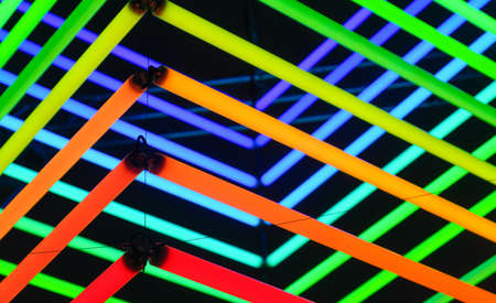 Neon lights as a background. Installation of neon lines for the design. An art installation of colored lights. Photo in high resolution.の写真素材