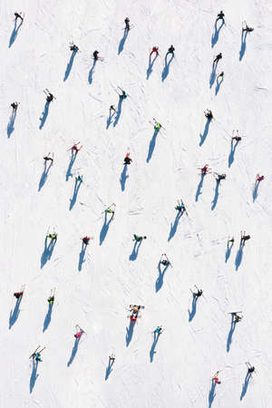 Ski resort. Aerial view of skiers and snowboarders. Winter sports. Snow slope in the mountains for sports. Photo in high resolution for the background.の写真素材