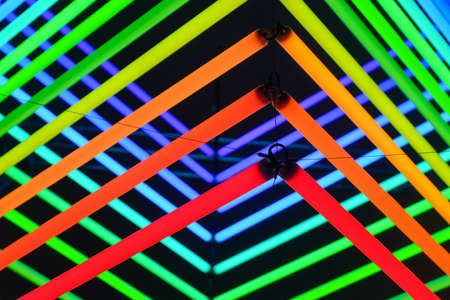 Neon lights as a background. Installation of neon lines for the design. An art installation of colored lights. Photo in high resolution.の写真素材