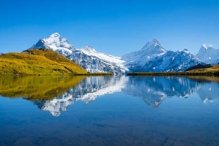 Bachalpsee, Grindelwald, Switzerland. High mountains and reflection on the surface of the lake. Landscape in the highlands in the summertime. Photo in high resolution.の写真素材