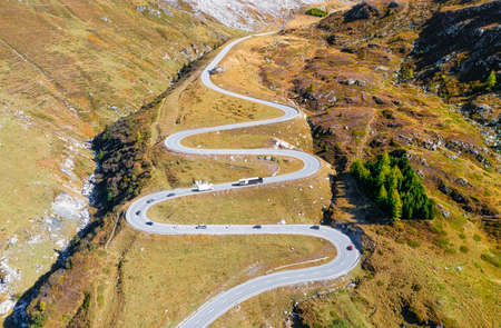 A road with turns through a mountain pass. Aerial landscape. An aerial summer landscape in the Dolomite Alps, Italy. Meadow and road.の写真素材
