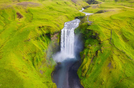 Iceland. Aerial view on the Skogafoss waterfall. Landscape in the Iceland from air. Famous place in Iceland. Landscape from drone.の写真素材