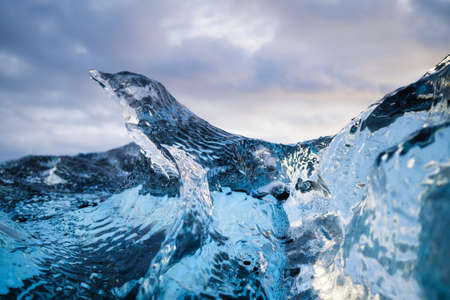 Diamond beach, Iceland. Pieces of icebergs with clear ice. Reflections and light in the ice during...