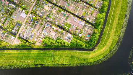 Aerial view of vegetable gardens. Netherlands. Canals with water for agriculture. Fields and meadows. Landscape from a drone.の写真素材