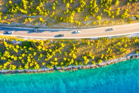 View of the road along the coast from the drone. Travel by car in summer time. The sea coast and the road. The coast of Europe.の写真素材