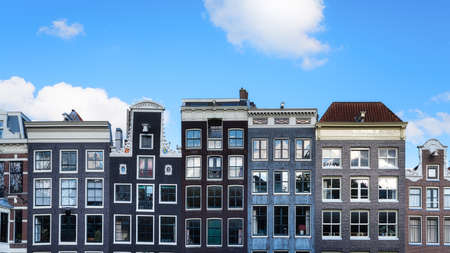 Amsterdam, Netherlands. Views of houses and clear blue skies. Famous Danish houses. Cityscape in the daytime. Travel photography.の写真素材