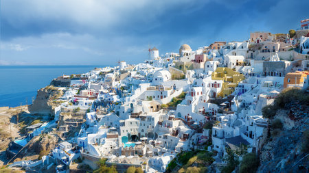 Oia village, Santorini, Greece. View of traditional houses in Santorini. Small narrow streets and rooftops of houses, churches and hotels. Panorama. Travel and vacation photography.の写真素材